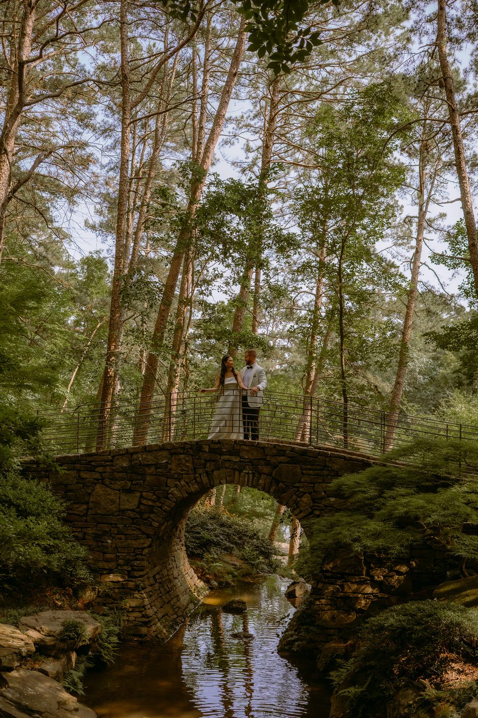 Documentary wedding couple on the stone bridge at Anthony Chapel in Central Arkansas