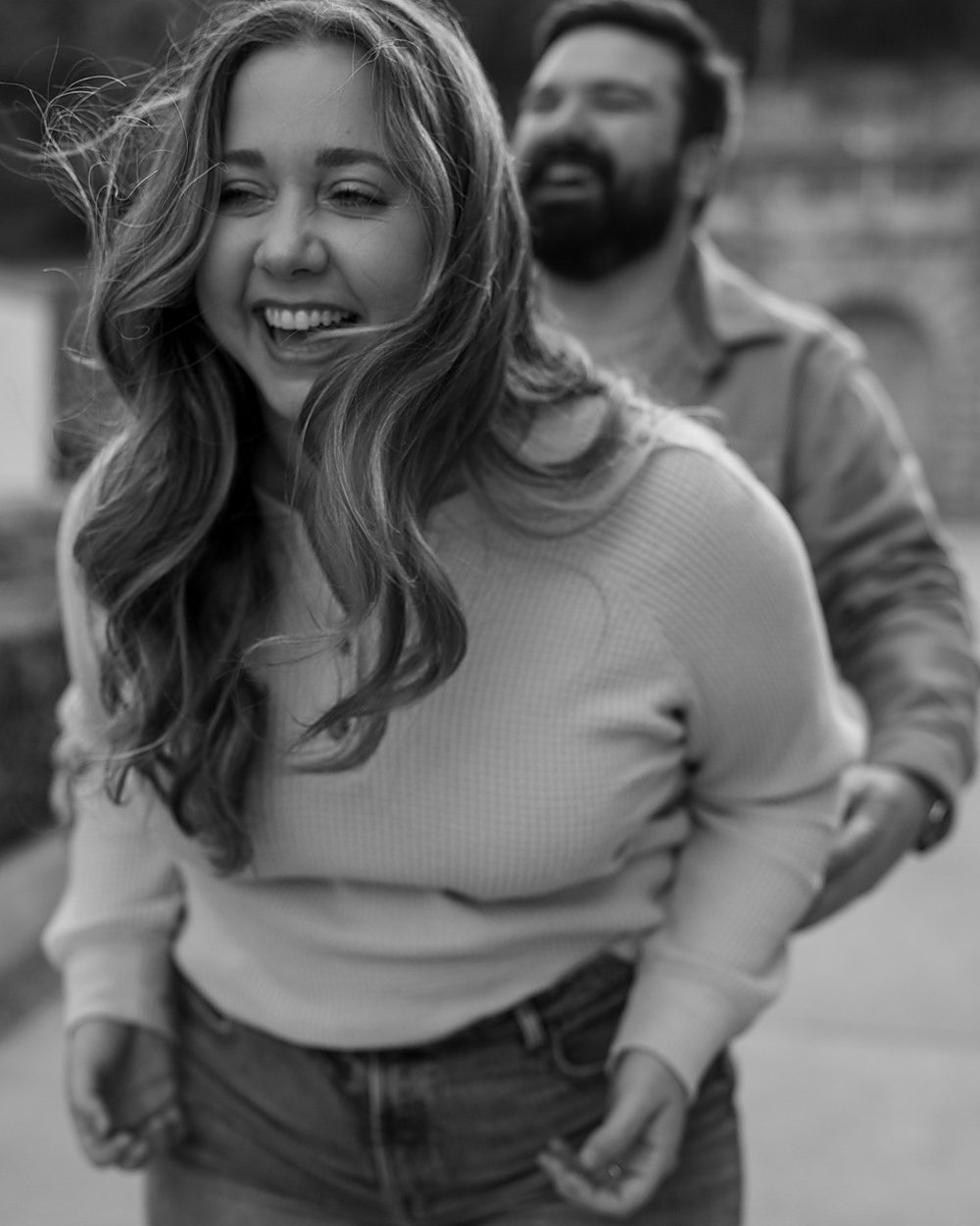 Candid black and white moment of a laughing couple, documentary photography in Central Arkansas