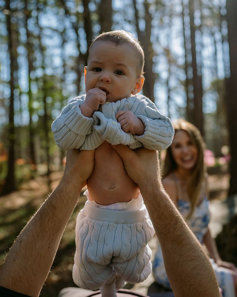 Documentary family session lifting their baby in Central Arkansas