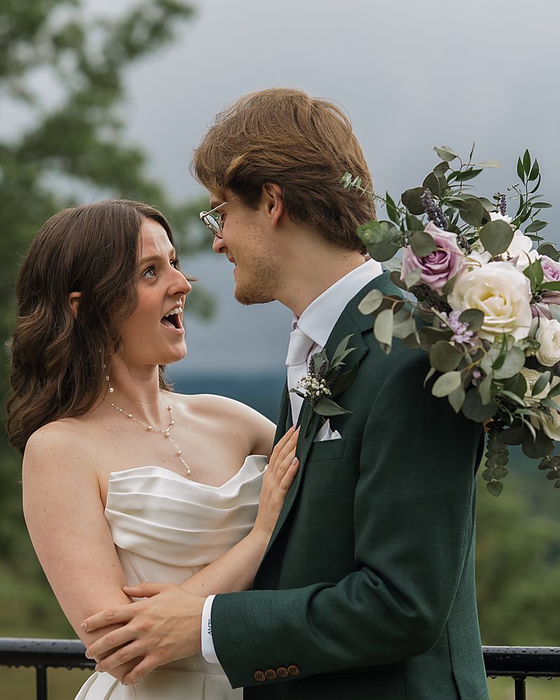 Bride and groom laughing forehead to forehead at a Central Arkansas hilltop wedding