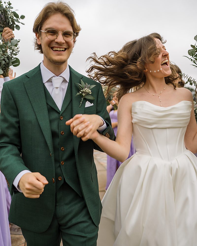 Groom and bride laughing with the wedding party at a Central Arkansas wedding